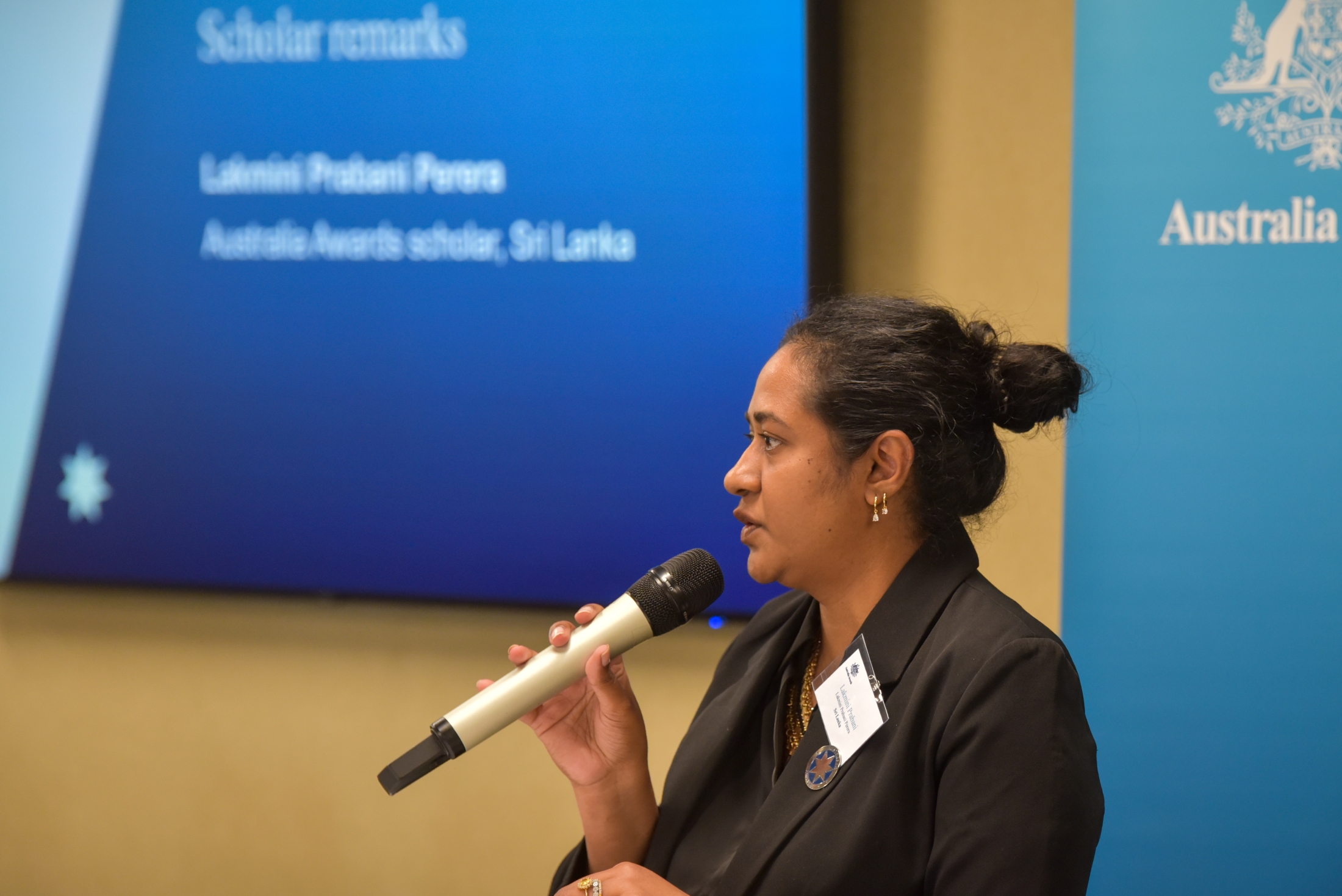 Lakmini delivering scholar remarks at the 2025 Scholars Symposium in Adelaide.