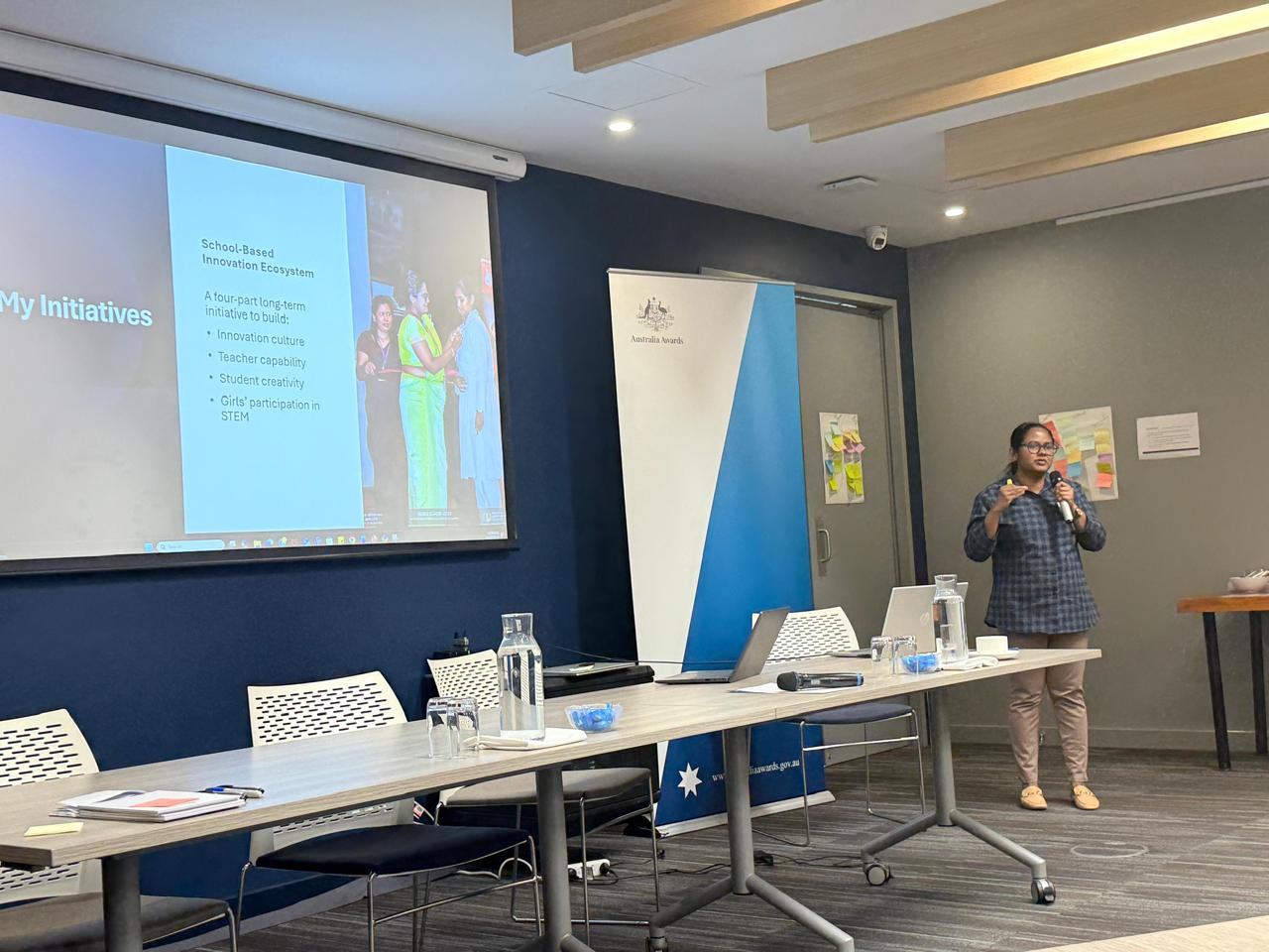 Gayathri presenting school innovation ecosystems and system transformation at the 2025 Scholar Symposium in Perth.